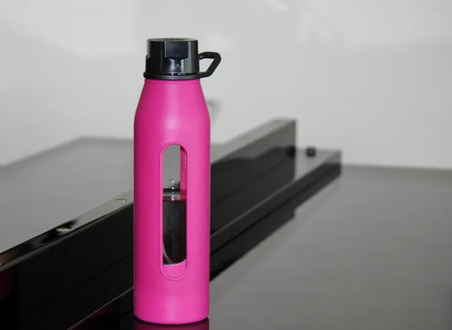 water bottle, hot pink bottle, water, bottle, piano, drink, pink, liquid, gray water, gray bottle, nature, gray piano. How to measure promotional merchandise campaigns and report the results