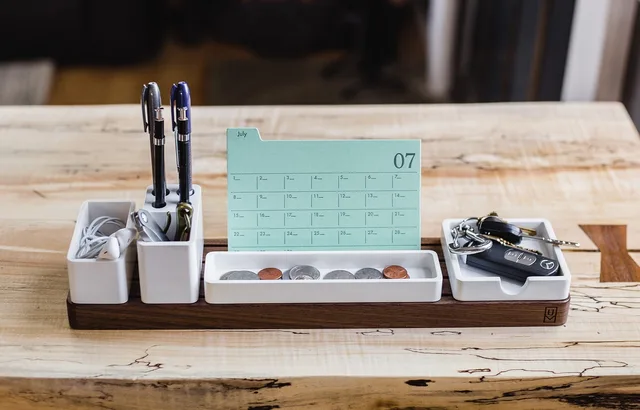 calendar, display, pens, key, earphones, coins, accessories, wooden, table, brown calendar, brown key. A promotional merchandise ninety day plan keeps a small budget honest